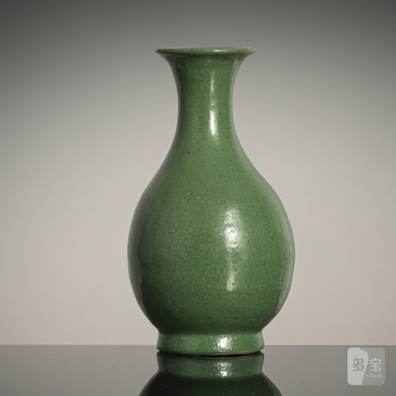 A small apple-green porcelain bottle vase